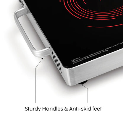 Portable electric stove with sturdy handles and anti-skid feet on a white background