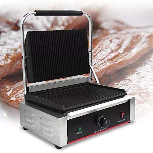 Panini press with a blurred background of bread slices